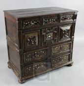 A late 17th century mother of pearl inlaid oak chest, of four geometric panelled drawers, with