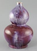 A Chinese flambe glazed double gourd vase, late 19th / early 20th century, pseudo Qianlong mark to