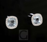 A modern pair of 18ct white gold, diamond and aquamarine ear studs, of shaped circular form, the two