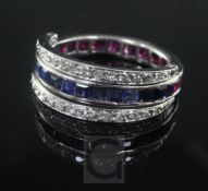 A white gold, sapphire, ruby and diamond set triple band swivel ring, size R.