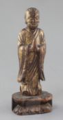 A Chinese giltwood figure of a Luohan, Ming dynasty or earlier, in standing pose, his hands held