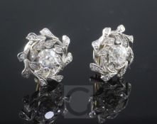 A pair of white gold and diamond cluster ear clips, of whorl design, each set with a central old