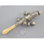 A 19th century ivory handled silver child's rattle, with six bells and engraved decoration, maker'