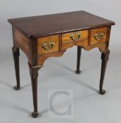 A George III mahogany lowboy, fitted three drawers, on turned tapered legs with pad feet, W.2ft 6in.