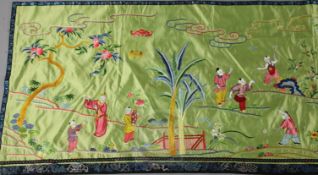 A Chinese embroidered silk wall hanging, early 20th century, decorated with boys playing in a garden