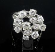 An 18ct white gold and free form diamond cluster ring, set with twelve graduated round cut stones,