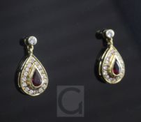 A pair of 18ct gold ruby and diamond pear shaped drop earrings, 15mm.