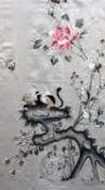 An unusual Chinese embroidered silk 'cat' panel, late Qing dynasty, decorated with a smiling cat