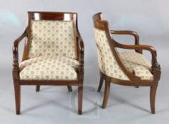 A pair of Regence style mahogany library chairs with dolphin carved arms H.2ft8in.