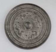 A Chinese bronze circular mirror, Han dynasty, 2nd century B.C.- 2nd century A.D., cast in relief