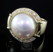 A modern 14ct gold, mabe pearl and diamond set dress ring, size T.