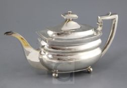A George III silver teapot by Andrew Fogelberg, of rounded rectangular form, with stag's head crest,