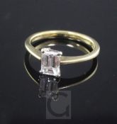 An 18ct gold and solitaire emerald cut diamond ring, the stone weighing approximately 0.60cts,