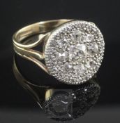 A 1970's Victorian style 9ct gold and diamond cluster ring, the central old mine cut stone