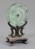 A Chinese bronze circular TLV mirror, Han dynasty or later, cast in low relief with a geometric