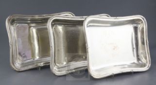 A set of three George IV silver entree dishes by William Eley II, of serpentine rectangular form,