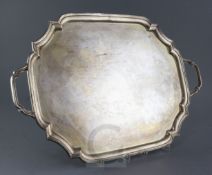 A 1940's silver two handled tea tray by Adie Brothers, of rectangular form with serpentine angles,