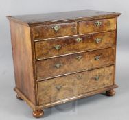 An early 18th century walnut chest, with quarter veneered top, two short and three graduated long