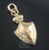 An early 20th century Russian 56 zolotnik gold shield shaped pendant, with cyrillic script and