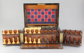 A Victorian amboyna games compendium, fitted with wooden chessmen, draughts, cribbage and other