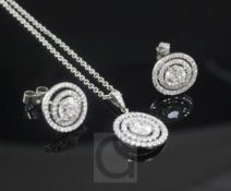 A white gold and diamond set target pendant on a platinum chain and a pair of similar 18ct white