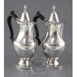 A pair of George V silver hot water or cafe au lait pots by Nathan & Hayes, of ovoid baluster