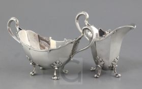 A George V Asprey & Co Ltd silver helmet shaped cream jug and boat shaped two handled sugar bowl, of