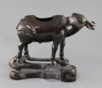 A Chinese bronze 'buffalo' bronze censer, Ming dynasty, in standing pose on an openwork base, length