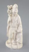 A Japanese ivory okimono of priest and a child, Meiji period, the priest standing and holding a