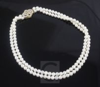 A double strand cultured pearl choker necklace with 18ct gold and diamond set clasp, 34cm.