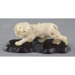 A Japanese ivory okimono of a lion and cub, early 20th century, the lion with glass inset eyes,