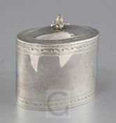 A George V 18th century style silver oval tea caddy, with bright cut engraved decoration and