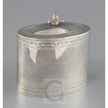 A George V 18th century style silver oval tea caddy, with bright cut engraved decoration and