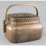 A large Chinese copper alloy hand warmer, 17th / 18th century, the front engraved and chased with