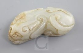 A Chinese pale celadon and russet jade figure of a recumbent beast, Qing dynasty, 5.1cm