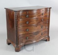 A George III mahogany serpentine fronted chest, with brushing slide and four graduated long drawers,
