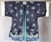 A Chinese midnight blue satin robe, late Qing dynasty, decorated with butterflies and peonies