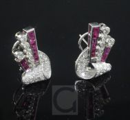 A pair of 1940's platinum and gold, ruby and diamond earrings, of scrolling and tapering design, set