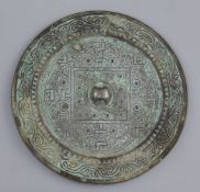 A Chinese bronze circular TLV mirror, Han dynasty, 1st century B.C., cast in low relief with a