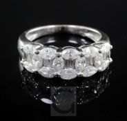 A modern 18ct white gold and graduated diamond cluster half hoop ring, set with five marquise and