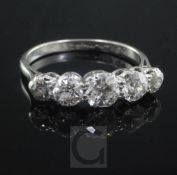 A mid 20th century platinum and graduated five stone diamond ring, set with old round cut stones,