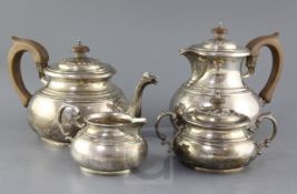 A 1940's four piece silver tea service by Goldsmiths & Silversmiths Co Ltd, of squat pear form, with