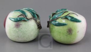 A pair of Chinese enamelled porcelain models of peaches, 19th century, each applied with leaf