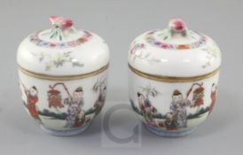 A pair of Chinese famille rose small jars and covers, 19th century, each finely painted with boys in