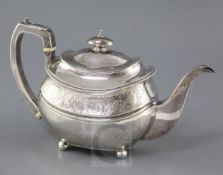 A George III silver oval teapot, by Wallis & Hayne, with engraved foliate band, on four ball feet,