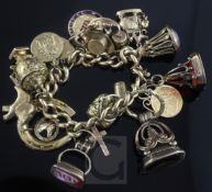 A 9ct gold charm bracelet hung with approximately nineteen assorted charms including 9ct gold and