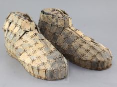 A pair of Chinese archaic sectional grey-green jade shoes, probably Han dynasty, composed of