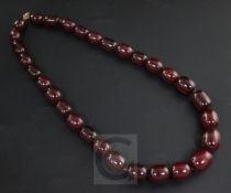 A single strand graduated simulated cherry amber bead necklace, gross 95 grams. 56cm.