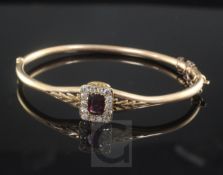 A late Victorian 15ct gold, almandine garnet and diamond set hinged bangle, with central rectangular