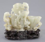 A Chinese pale celadon jade 'phoenix' vessel, 18th / 19th century, carved in high relief and